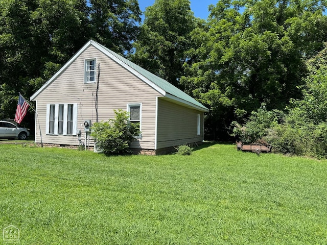 731 S Thornton Ave, Piggott, AR 72454 - view of property exterior featuring a lawn and crawl space