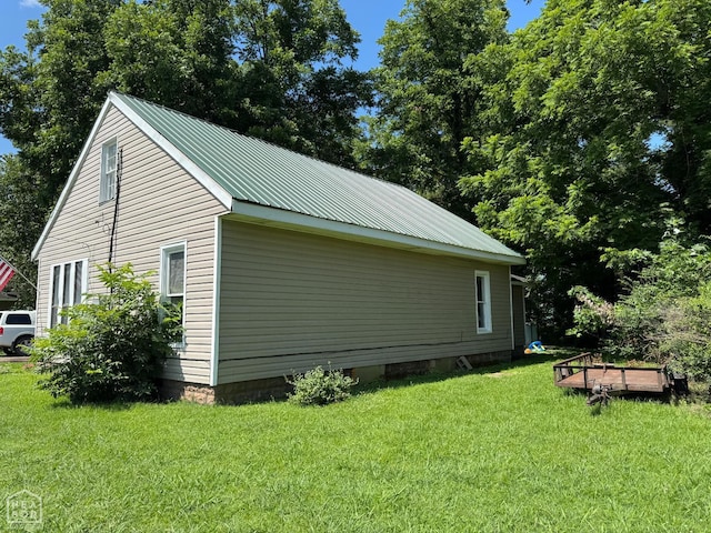 731 S Thornton Ave, Piggott, AR 72454 - view of home's exterior featuring a yard and a metal roof