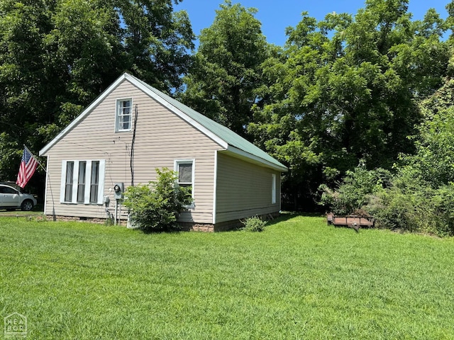 731 S Thornton Ave, Piggott, AR 72454 - view of property exterior featuring a lawn and crawl space