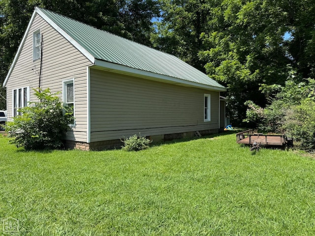 731 S Thornton Ave, Piggott, AR 72454 - view of property exterior featuring a lawn and a metal roof