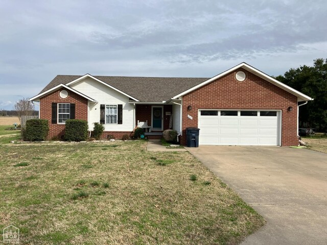 ranch-style house featuring driveway, brick siding, a garage, a shingled roof, and a front yard