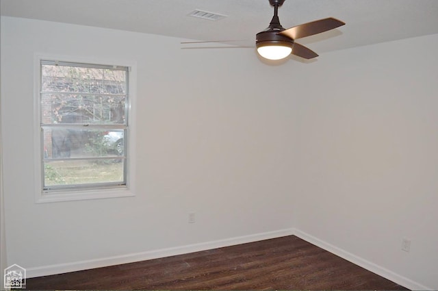 203 Scott St, Jonesboro, AR 72401 - spare room featuring a ceiling fan, baseboards, and dark wood-style flooring