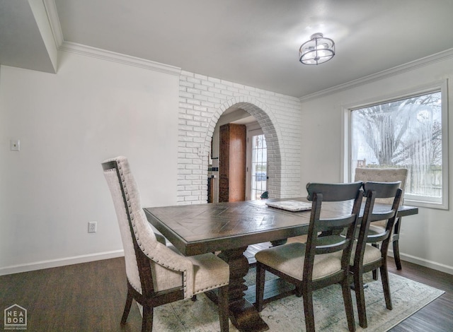 1721 W Main Extended, Trumann, AR 72472 - dining area featuring arched walkways, ornamental molding, wood finished floors, brick wall, and baseboards