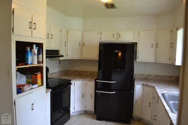 1808 Roy St, Jonesboro, AR 72401 - kitchen featuring black appliances, under cabinet range hood, light countertops, and light tile patterned flooring