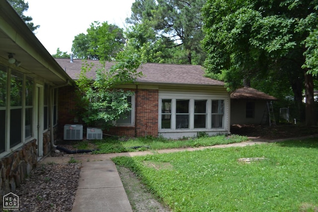 1808 Roy St, Jonesboro, AR 72401 - view of front of house with brick siding, a front lawn, and a shingled roof