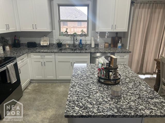 302 Hollis St, Bono, AR 72416 - kitchen featuring white cabinets, backsplash, stone countertops, a sink, and appliances with stainless steel finishes