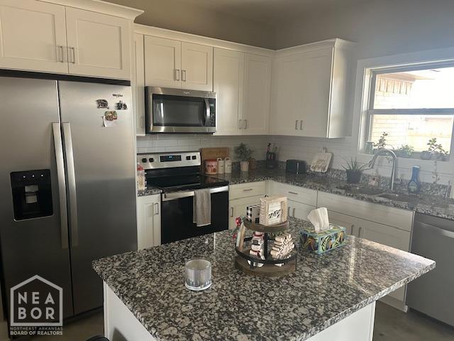 302 Hollis St, Bono, AR 72416 - kitchen featuring stainless steel appliances, a sink, white cabinetry, and tasteful backsplash