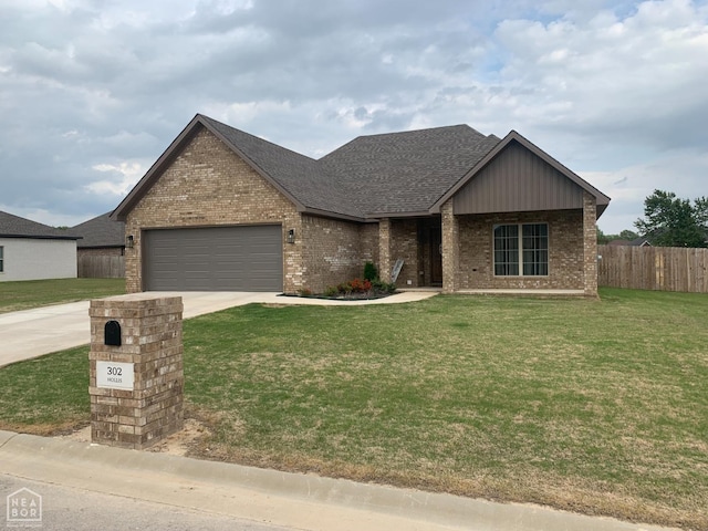 302 Hollis St, Bono, AR 72416 - view of front of house with fence, an attached garage, driveway, and brick siding