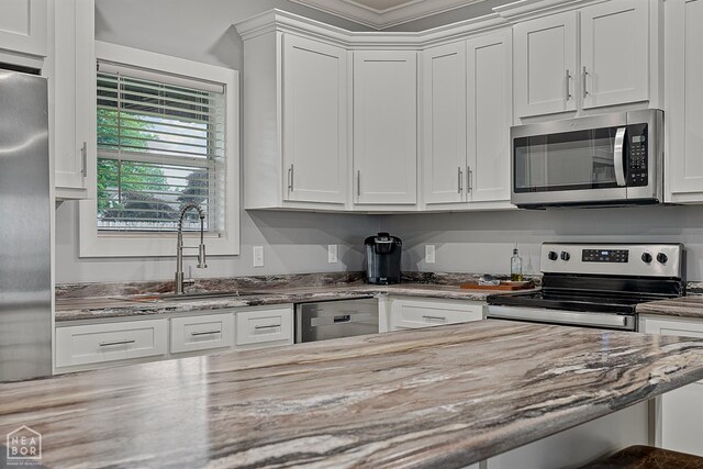 716 Gabe Ln, Manila, AR 72442 - kitchen featuring appliances with stainless steel finishes, a sink, white cabinetry, and light stone counters