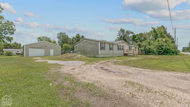 338 Buttercup Ln, Manila, AR 72442 - view of front of property featuring dirt driveway, a detached garage, a front lawn, and an outbuilding