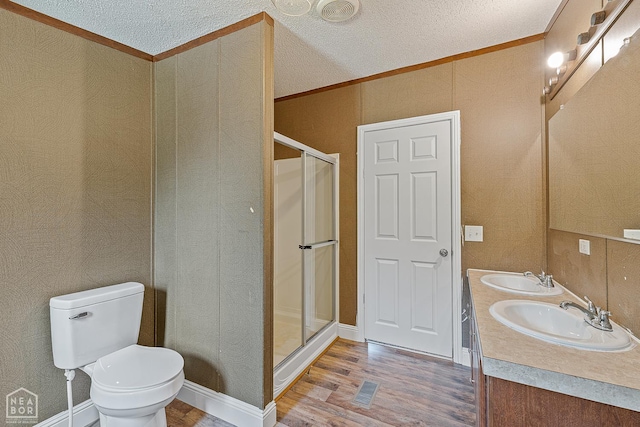 338 Buttercup Ln, Manila, AR 72442 - full bath with wood finished floors, ornamental molding, a shower stall, a textured ceiling, and double vanity