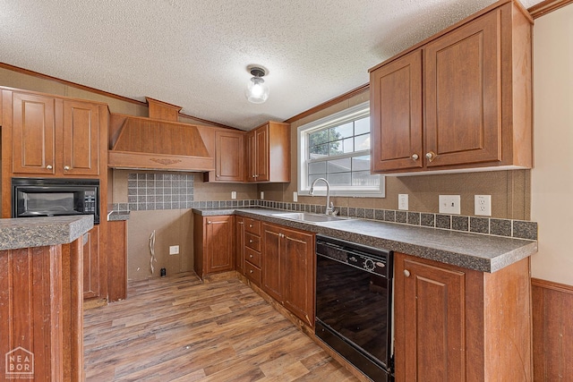 338 Buttercup Ln, Manila, AR 72442 - kitchen featuring black appliances, custom range hood, light wood finished floors, dark countertops, and brown cabinets