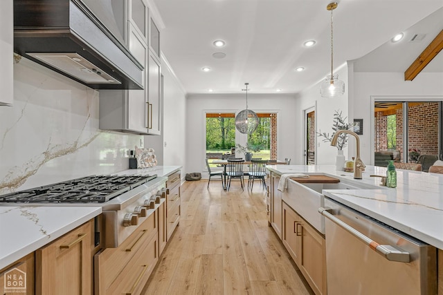 126 County Road 7459, Jonesboro, AR 72401 - kitchen with appliances with stainless steel finishes, wall chimney range hood, light wood-type flooring, pendant lighting, and recessed lighting