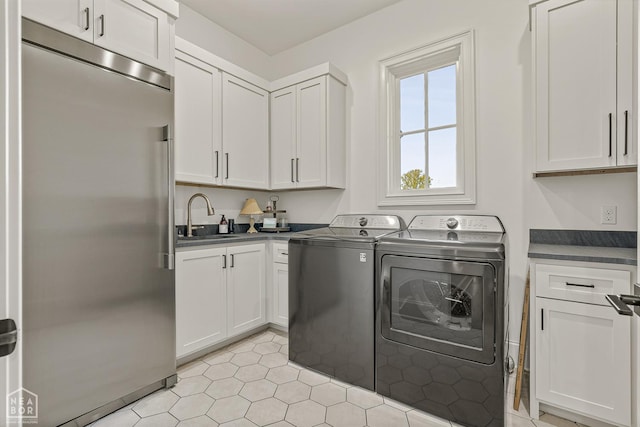 126 County Road 7459, Jonesboro, AR 72401 - laundry room featuring washer and clothes dryer and cabinet space