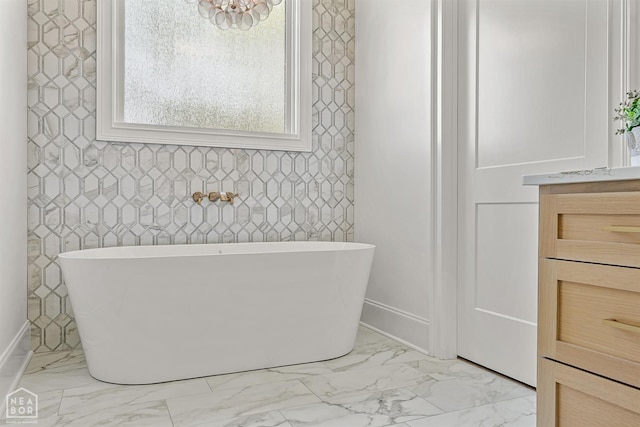 126 County Road 7459, Jonesboro, AR 72401 - bathroom with marble finish floors, a freestanding bath, and vanity