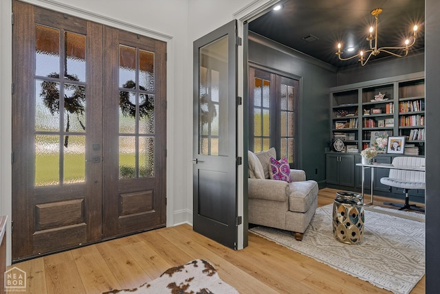 126 County Road 7459, Jonesboro, AR 72401 - entrance foyer with french doors, a chandelier, and hardwood / wood-style flooring
