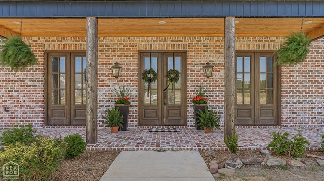 126 County Road 7459, Jonesboro, AR 72401 - entrance to property with french doors, brick siding, and covered porch