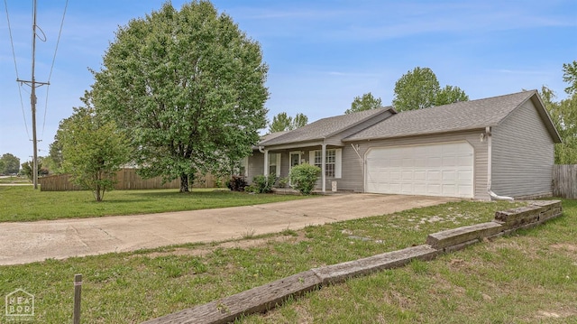 ranch-style home with roof with shingles, a garage, fence, a front lawn, and concrete driveway