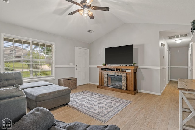 living room with visible vents, light wood-style flooring, ceiling fan, and lofted ceiling