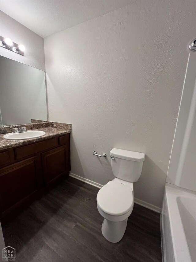 3721 Churchill Dr, Jonesboro, AR 72404 - bathroom with wood finished floors, vanity, and baseboards