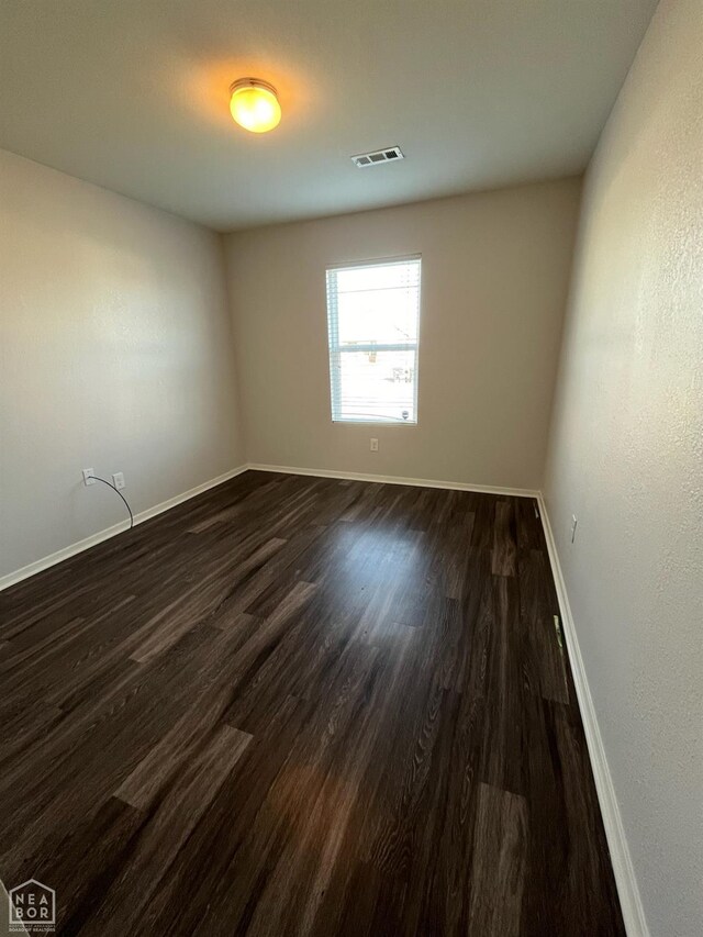 3721 Churchill Dr, Jonesboro, AR 72404 - empty room featuring dark wood-type flooring and baseboards