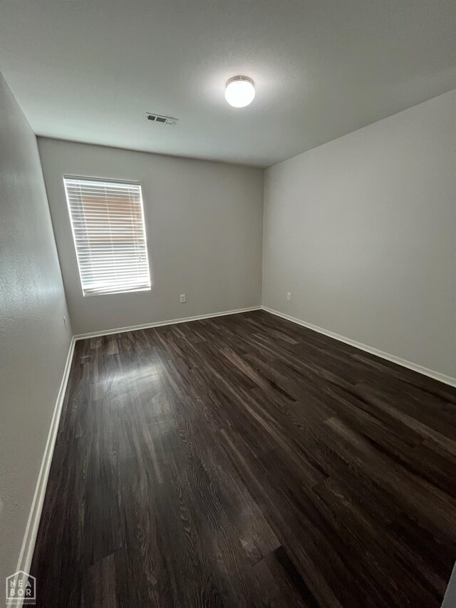 3721 Churchill Dr, Jonesboro, AR 72404 - unfurnished room with dark wood-type flooring and baseboards