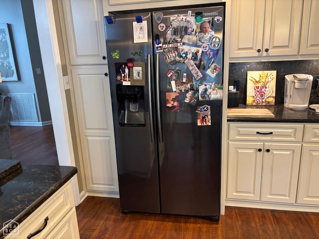 2208 Shafer Cir, Newport, AR 72112 - kitchen with black fridge, dark wood-type flooring, and white cabinets
