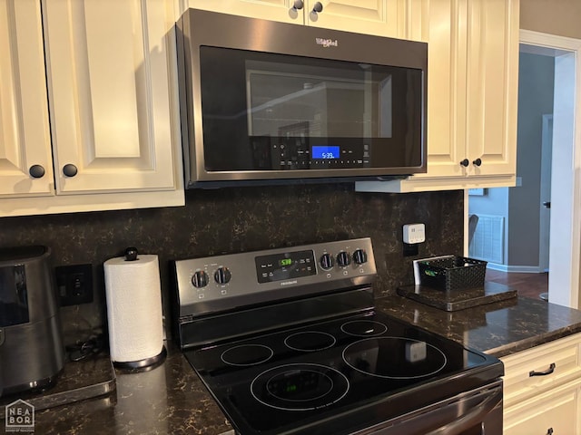 2208 Shafer Cir, Newport, AR 72112 - kitchen view of stainless steel appliances, tasteful backsplash, dark stone counters, and white cabinets