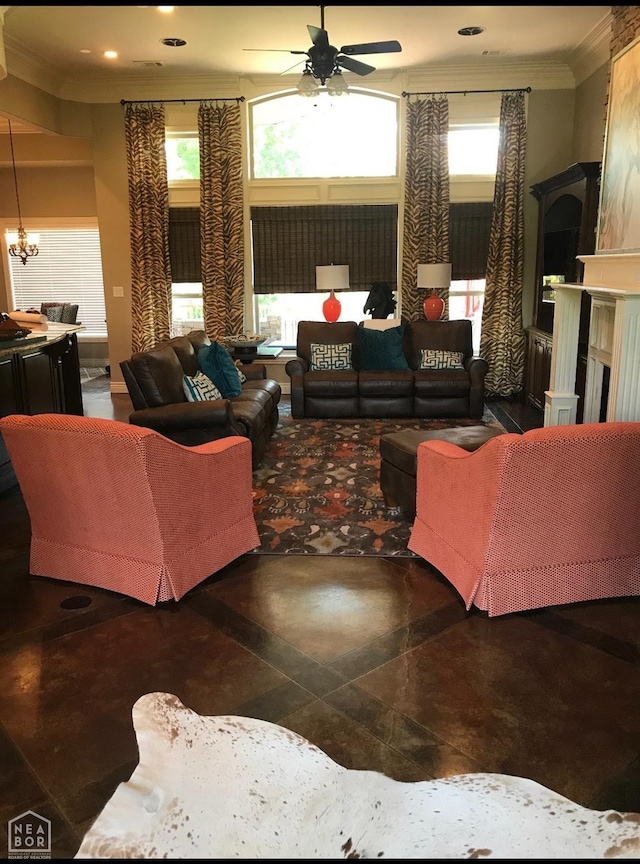living area with ceiling fan, a fireplace, ornamental molding, and a towering ceiling