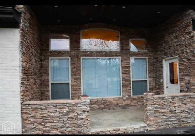exterior space featuring stone siding