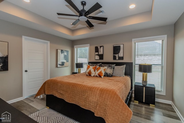 1011 S 59th St S, Paragould, AR 72450 - bedroom with wood finished floors, a tray ceiling, recessed lighting, and a ceiling fan