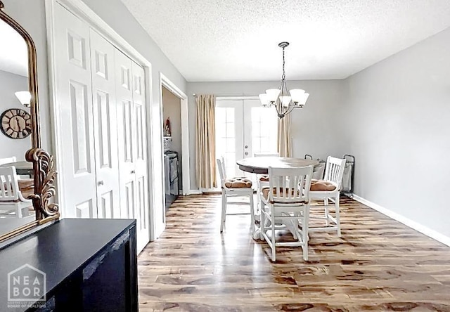 199 County Road 305, Jonesboro, AR 72401 - dining area featuring a textured ceiling, wood finished floors, a chandelier, and baseboards