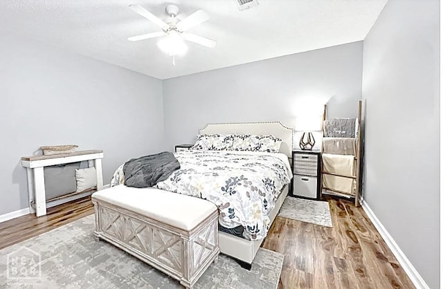 199 County Road 305, Jonesboro, AR 72401 - bedroom with wood finished floors, a ceiling fan, and baseboards