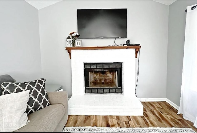 199 County Road 305, Jonesboro, AR 72401 - living area featuring a fireplace, wood finished floors, and baseboards