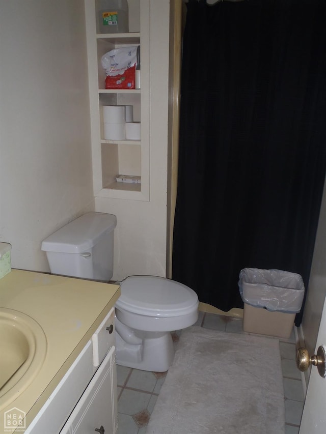 2009 Daugherty St, Newport, AR 72112 - bathroom with toilet, vanity, and tile patterned flooring