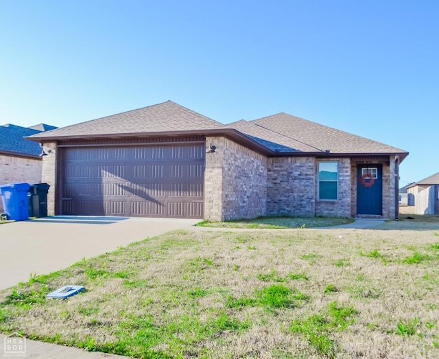 5632 Brookshire Dr, Jonesboro, AR 72405 - view of front facade featuring concrete driveway, an attached garage, brick siding, and a shingled roof