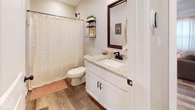 5632 Brookshire Dr, Jonesboro, AR 72405 - full bath featuring toilet, a shower with shower curtain, vanity, and wood finished floors