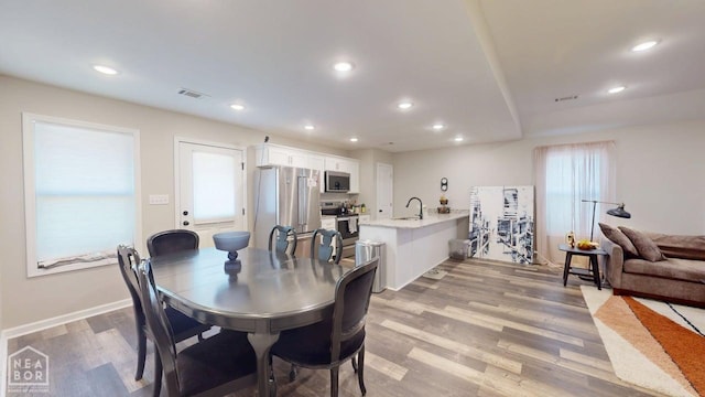 5632 Brookshire Dr, Jonesboro, AR 72405 - dining area featuring baseboards, visible vents, light wood finished floors, and recessed lighting