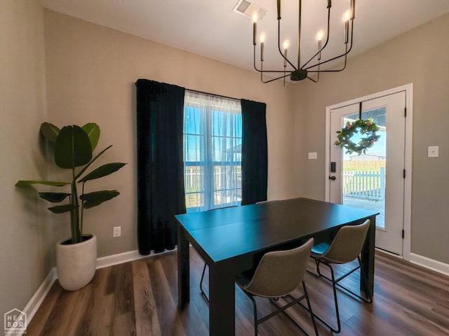 109 Old Eli Rd, Monette, AR 72447 - dining area with dark wood-type flooring, visible vents, baseboards, and an inviting chandelier
