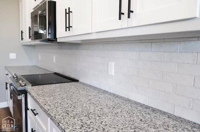 109 Old Eli Rd, Monette, AR 72447 - kitchen featuring decorative backsplash, appliances with stainless steel finishes, light stone counters, and white cabinets