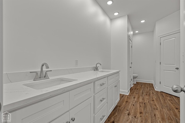 1816 N Oak, Brookland, AR 72417 - full bath with double vanity, wood finished floors, and recessed lighting