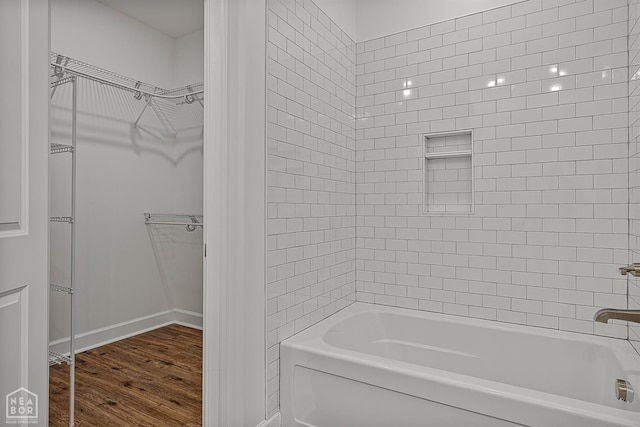1816 N Oak, Brookland, AR 72417 - full bathroom with wood finished floors, bathtub / shower combination, and a walk in closet