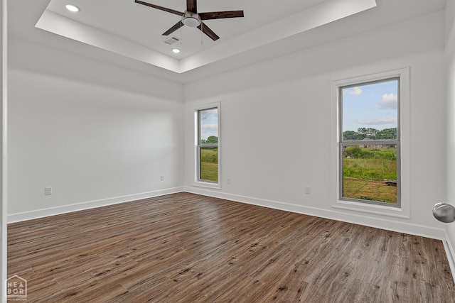 1816 N Oak, Brookland, AR 72417 - unfurnished room featuring a tray ceiling, dark wood-style flooring, ceiling fan, and recessed lighting