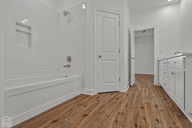 1816 N Oak, Brookland, AR 72417 - full bath with shower / washtub combination, wood finished floors, and vanity