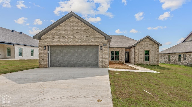 1816 N Oak, Brookland, AR 72417 - view of front of property featuring concrete driveway, an attached garage, a front lawn, and brick siding