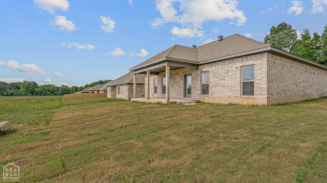 1816 N Oak, Brookland, AR 72417 - rear view of property with a patio, brick siding, and roof with shingles