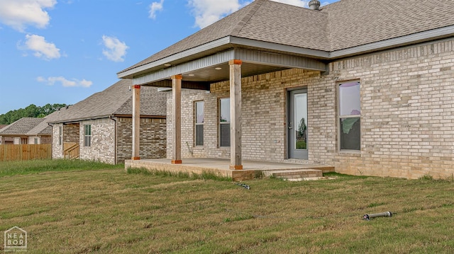 1816 N Oak, Brookland, AR 72417 - back of house featuring a patio area, brick siding, and a shingled roof