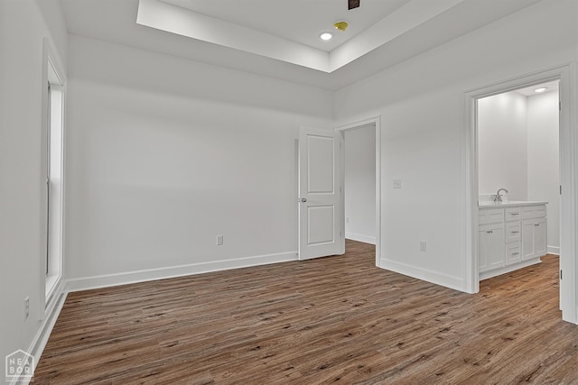 1816 N Oak, Brookland, AR 72417 - unfurnished room featuring wood finished floors, a raised ceiling, and recessed lighting
