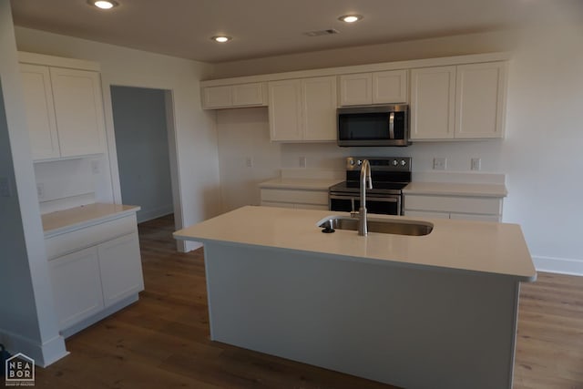 311 Hollis Cv, Bono, AR 72416 - kitchen with stainless steel appliances, wood finished floors, white cabinets, and recessed lighting