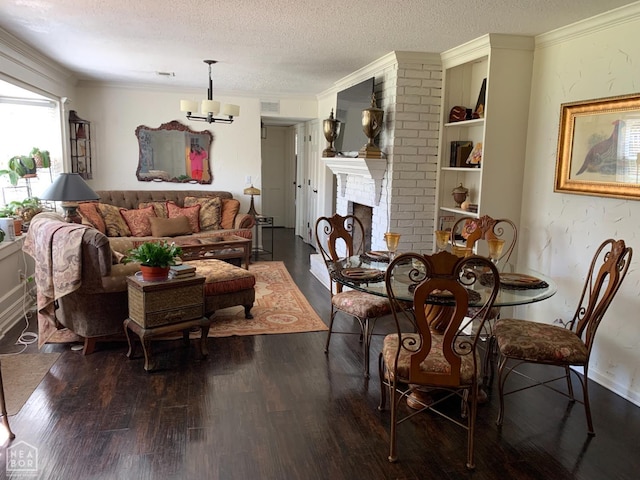 2704 Greenbriar Dr, Jonesboro, AR 72401 - dining space with a chandelier, dark wood-style floors, a textured ceiling, crown molding, and a brick fireplace